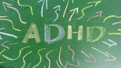 Colorful chalk-drawn ADHD letters surrounded by scattered arrows, symbolizing focus difficulties and hyperactivity.