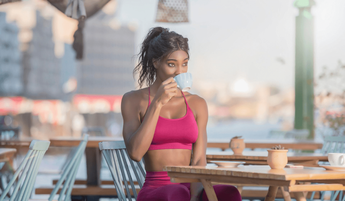 Boost energy and burn fat naturally—a fitness-focused woman enjoying her morning cup of Beneve Xcelerate Coffee.