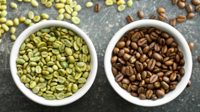 Comparison of green and roasted coffee beans in white bowls, highlighting differences in processing and caffeine content.